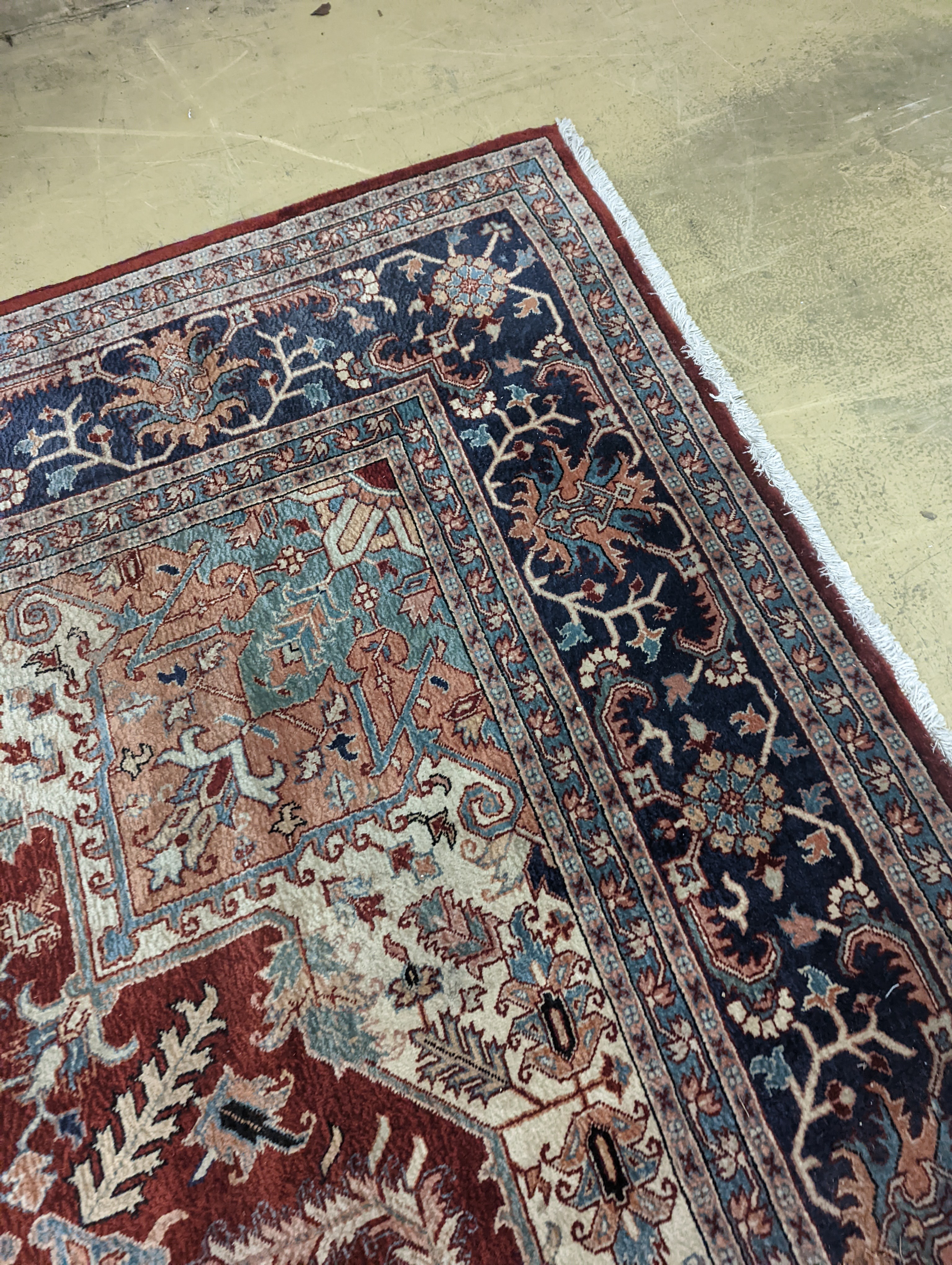 A large Caucasian style red ground carpet, 460 x 330cm